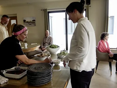 Claire serving food in dining room 07 | Retreat venue