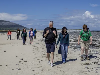 Group walking along sandy beach | Wellness Retreat Ireland