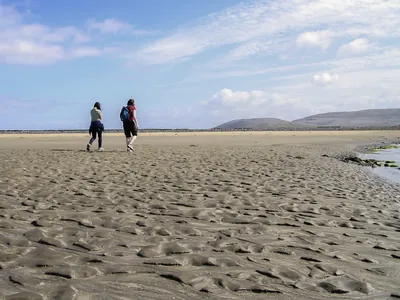 Sandy pattern on beach girls walking | yoga teachers retreat