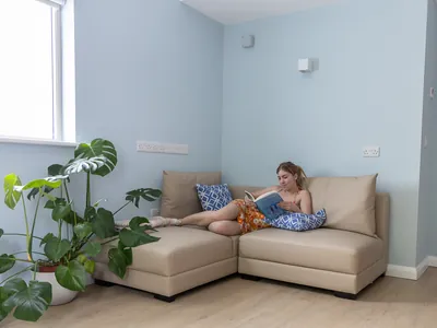 a woman reading a book on a couch