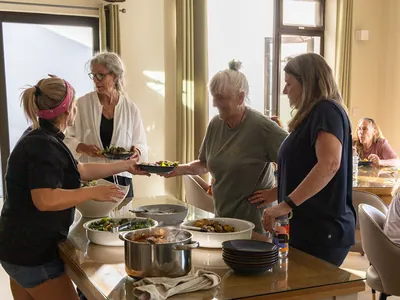 Claire serving Suzanne and 2 others | Retreat venue
