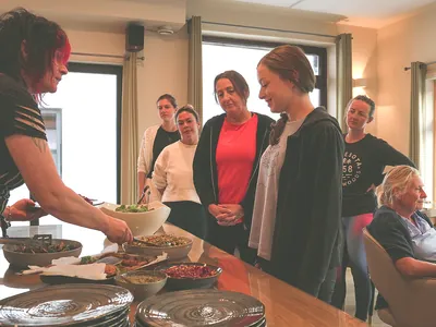Claire serving food mixed ages | Retreat venue