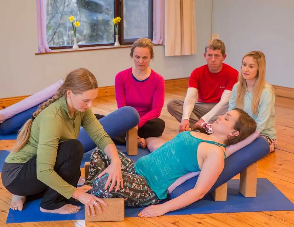 a group of people sitting on mats
